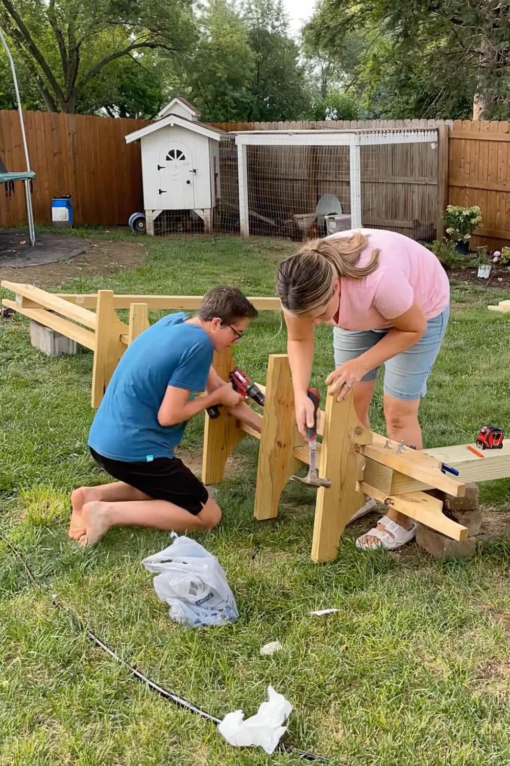 Adding braces to cross beams on a backyard hammock stand.